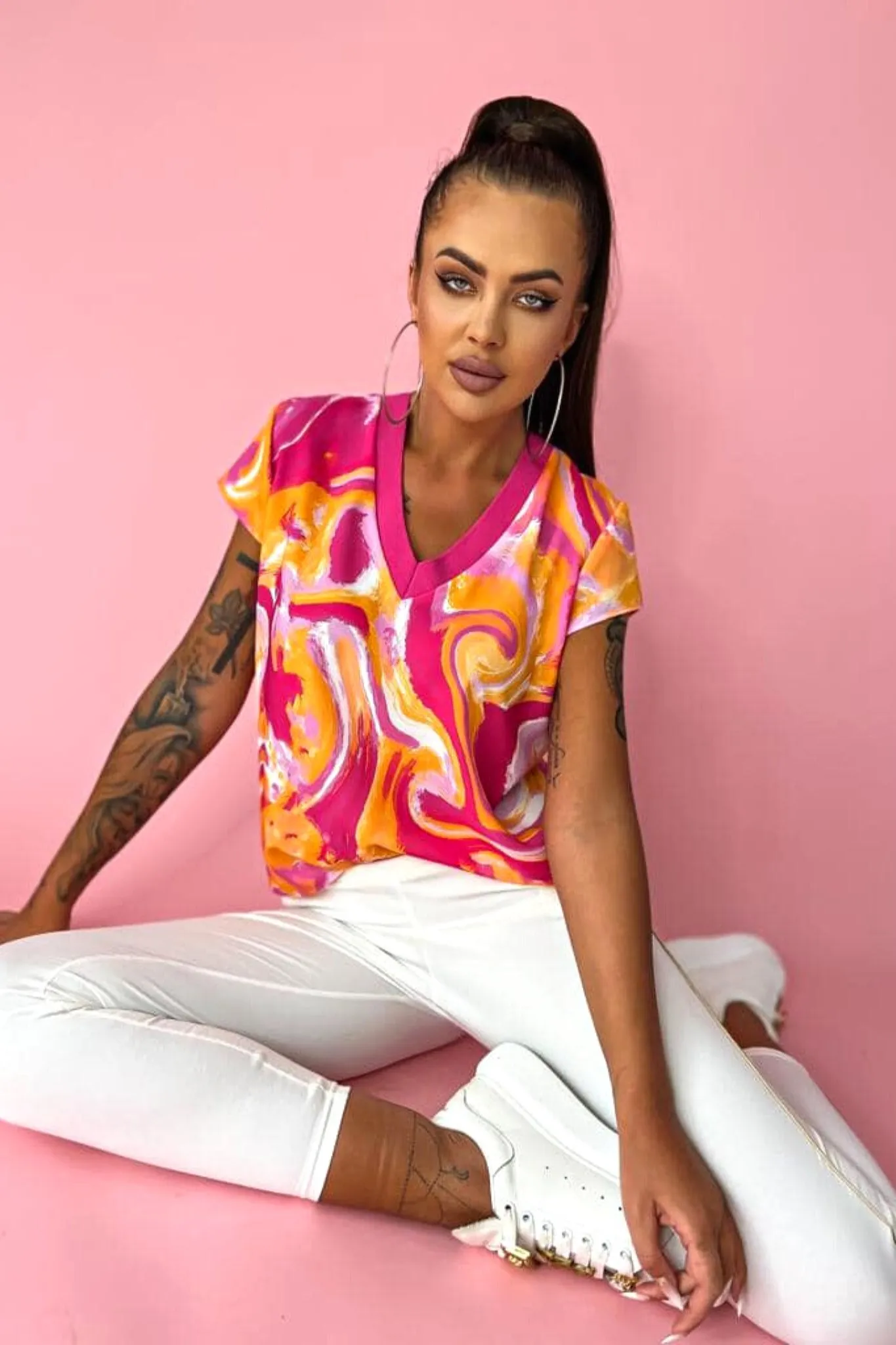 Blusa estiva con maniche corte a fantasia astratta tonalità arancione e fucsia